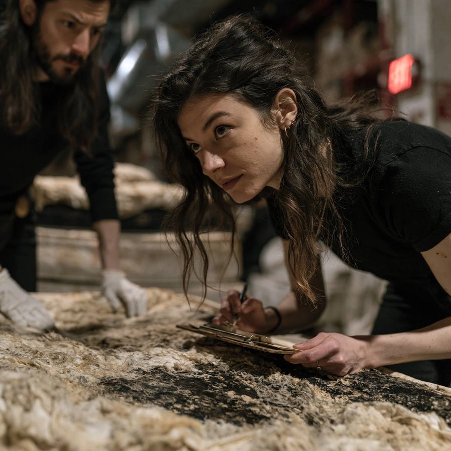 Sleep Historians examining a mattress closely at Warehouse 7